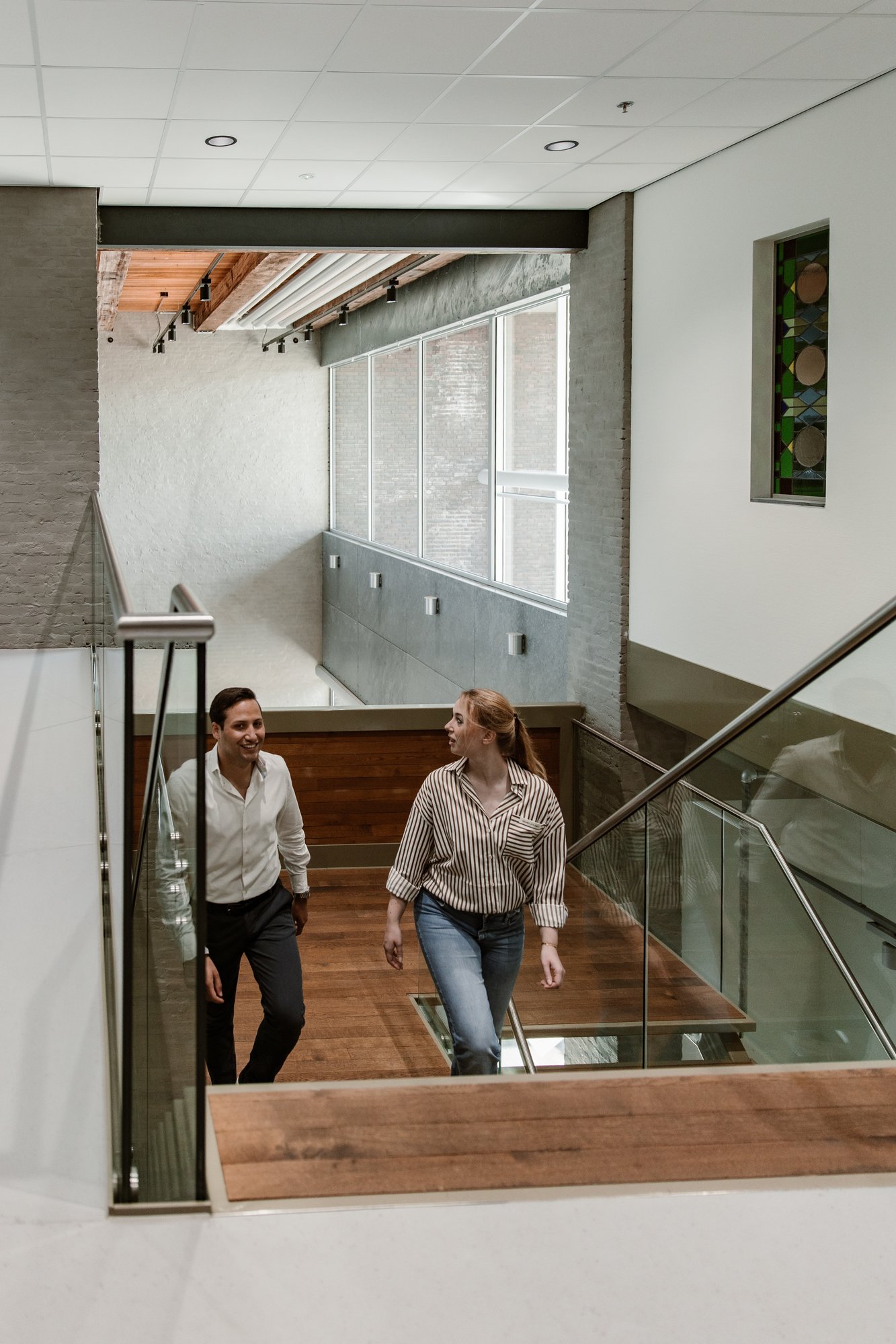 Two people walking up the stairs